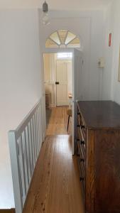 a hallway with a wooden floor and a staircase at Quinta das Vinhas in Calheta