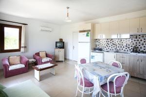 a kitchen and living room with a table and chairs at Flat w Nature View Balcony 1 min to Beach in Datca in Datca