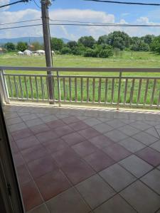 a balcony with a fence and a view of a field at Apartman MN in Čapljina