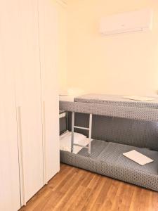 a room with a bunk bed and a desk at Hotel Perla Del Mare in Lido di Camaiore