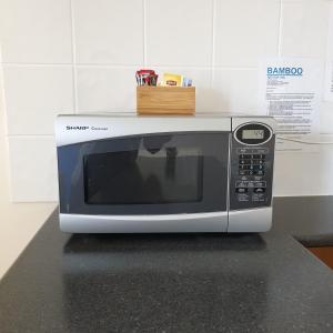 a microwave oven sitting on top of a counter at Bamboo Motor Inn in Lakes Entrance