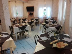 a room filled with tables and chairs with tablesktop at Hotel Villa Mon Reve in Rimini