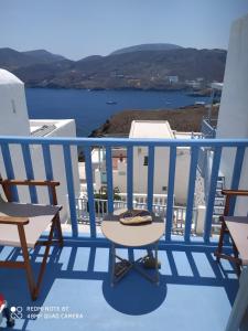 a table on a balcony with a view of the ocean at Aiolos TRADITIONAL HOUSE IN ASTYPALAIA in Astypalaia