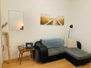 a living room with a couch and a table at Downtown Apartment in Horta
