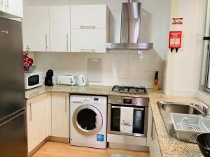 a kitchen with a washing machine and a sink at Downtown Apartment in Horta +7 photos