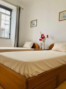 a large bed in a room with a window at Downtown Apartment in Horta +7 photos