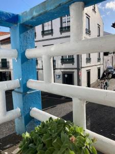 a blue and white fence in front of a building at Downtown Apartment in Horta