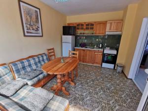 a living room with a couch and a table at Mira Home in Veliko Tŭrnovo +4 photos