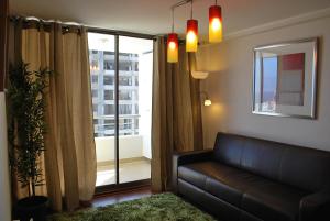 a living room with a couch and a window at Apartamento El Yodo in Antofagasta