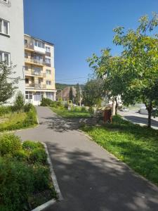 an empty street in a city with a building at La Sandu Ocna in Ocna Sibiului