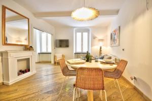 a dining room with a table and chairs and a fireplace at Casa dell'Arco - 1 min walking from the beach in Santa Margherita Ligure
