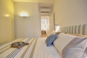 a bedroom with a bed with two dishes on it at Casa dell'Arco - 1 min walking from the beach in Santa Margherita Ligure