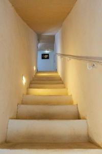 a staircase in a building with a sign on the wall at Zen Guest House Olistica in Alliste