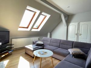 a living room with a couch and a table at Sielski wypoczynek blisko Kołobrzegu in Dębogard