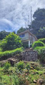 a house sitting on top of a hill at Heath Cote in Ooty