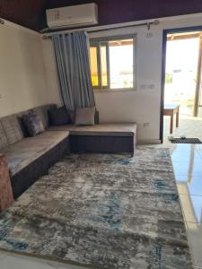 a living room with a couch and a rug at Hurghada, mubark6 in Hurghada