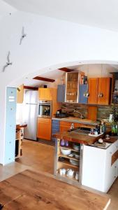 a kitchen with wooden cabinets and a white refrigerator at PaKua apartments & Penthouse with 2 terraces in Rovinj
