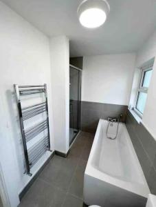 a bathroom with a white tub and a shower at The Chalet in Dungloe