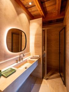 a bathroom with a sink and a mirror at Superbe ferme rénovée en chalet de luxe en PLEINE NATURE in Barcelonnette