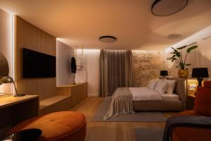 a hotel room with a bed and a television at Golden Gate Luxury Rooms - Unique UNESCO Location in Split