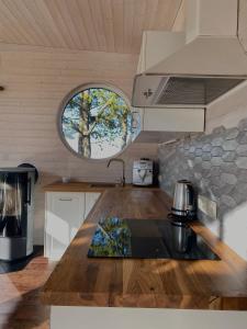 a kitchen with a wooden counter top and a window at Holiday House "Sea Nest" in Kalni