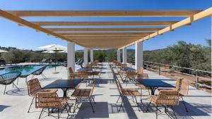 a row of tables and chairs next to a pool at Brisot in Galatas