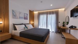 a hotel room with a bed and a desk and a room at Brisot in Galatas