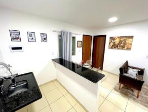 a bathroom with a sink and a mirror at Apartamento Perto do Aeroporto in Lauro de Freitas