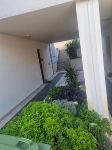 un jardín en el lateral de un edificio con plantas en Apartment Lara en Podstrana