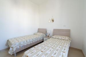Postel nebo postele na pokoji v ubytování Dimora le Dune a 100 MT dal mare
