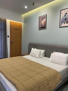 a bedroom with a large bed in a room at HOTEL NATURE AGRO RESORT in Sangamner