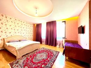 a bedroom with a bed and a red rug at Guesthouse Mtkvari in Nak'alak'evi