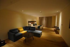 a hotel room with a couch and a bed at Best Western Premier Dynasty in Addis Ababa