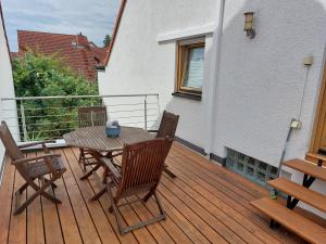a wooden deck with a table and chairs on it at Ferienwohnung in Worms in Worms