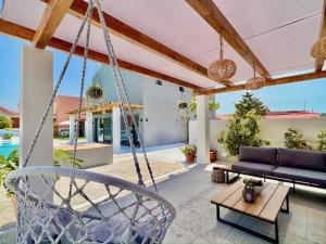 an outdoor patio with a swing and a couch at Villa Cielo with private pool in Canal D'Amour by DadoVillas in Sidari
