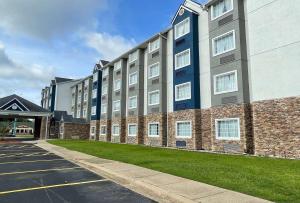 a large building with a parking lot in front of it at Microtel Inn & Suites by Wyndham Bossier City in Bossier City