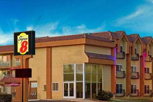 a hotel with a sign on the front of it at Super 8 by Wyndham Cypress Buena Park Area in Cypress