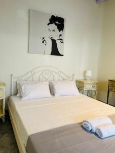 a bedroom with a bed with two towels on it at Aphrodite sunshine suite in Mýkonos City