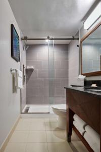 a bathroom with a shower and a toilet and a sink at Hilton Anchorage in Anchorage