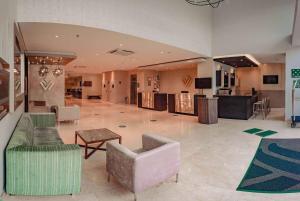 a lobby with couches and chairs and a table at Wyndham Garden Barranquilla in Barranquilla