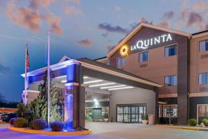 a hotel with a sign on the front of a building at La Quinta by Wyndham Ada in Ada