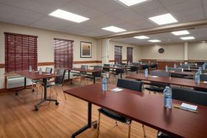 an empty classroom with tables and chairs in it at Days Inn & Suites by Wyndham Sherwood Park Edmonton in Sherwood Park
