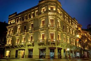 a large white building with lights on it at Esplendor by Wyndham Buenos Aires in Buenos Aires