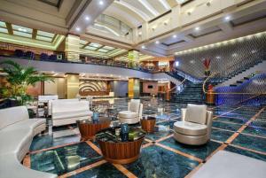 a lobby of a hotel with chairs and stairs at Wyndham Casablanca Jakarta in Jakarta