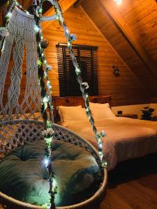 a bedroom with a bed with a rope swing at Lavinya Suit Bungalov in Rize