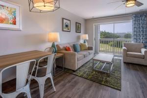 a living room with a couch and a table at Atlantic Beach Resort, a Ramada by Wyndham in Atlantic Beach