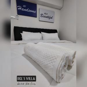 a white bed with white blankets and pillows on it at Dels Villa with private pool near UIA Batu Caves Gombak in Batu Caves