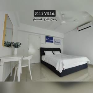 a bedroom with a bed and a desk and a sign at Dels Villa with private pool near UIA Batu Caves Gombak in Batu Caves
