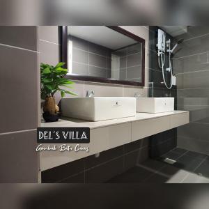 a bathroom with a white sink and a mirror at Dels Villa with private pool near UIA Batu Caves Gombak in Batu Caves