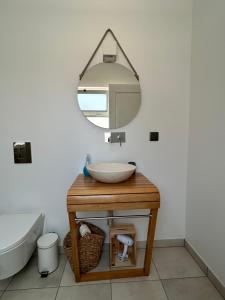 a bathroom with a sink and a mirror at Casa aOrta Studios in Faro
